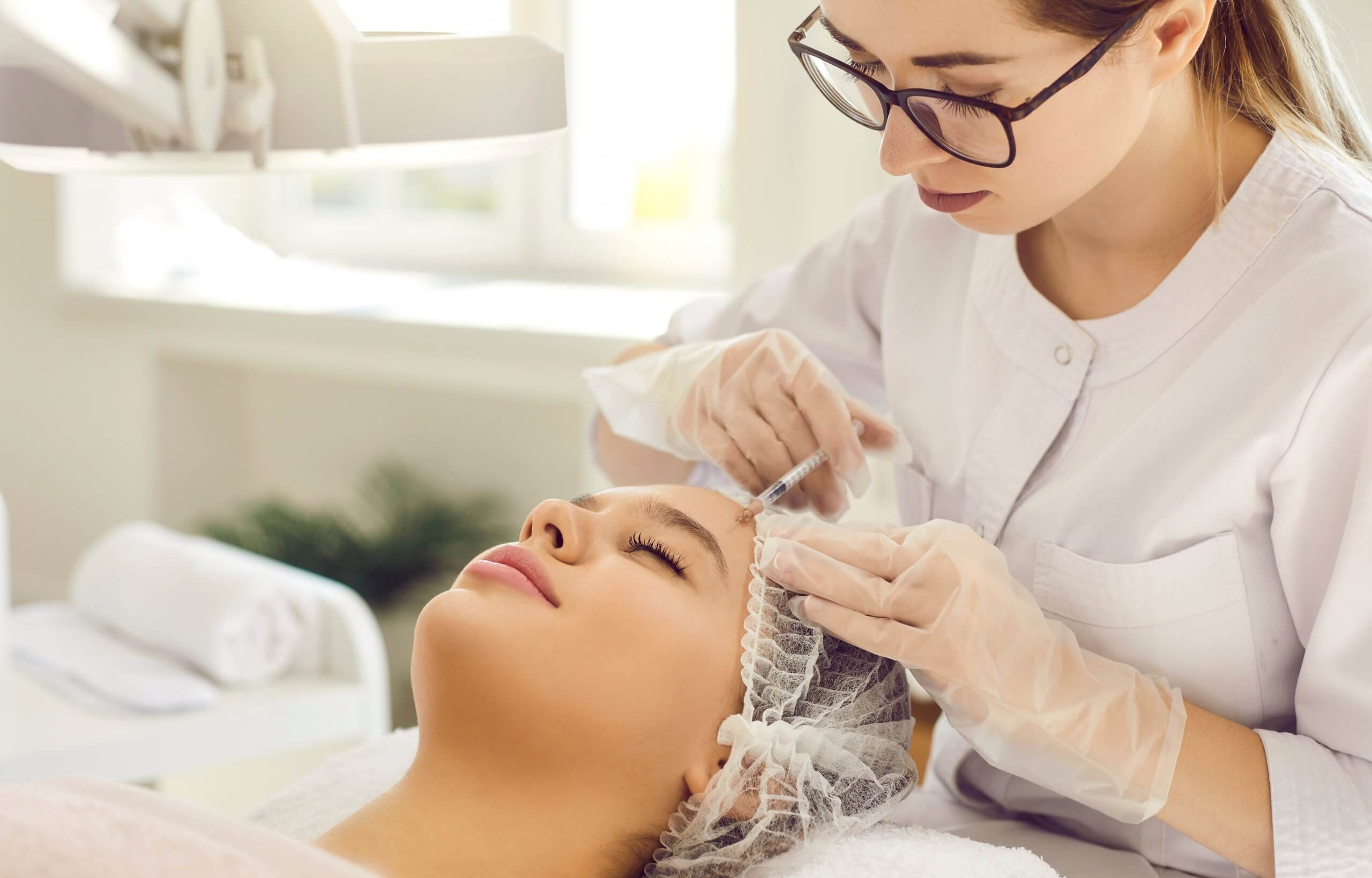 Natalie performing aesthetic treatment
